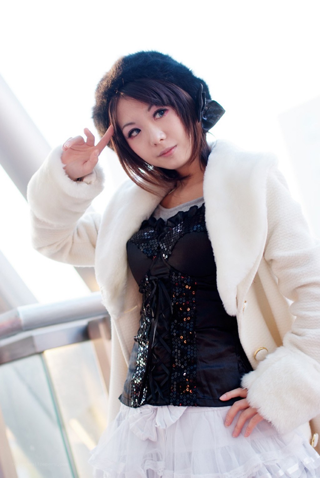 woman in white coat posing