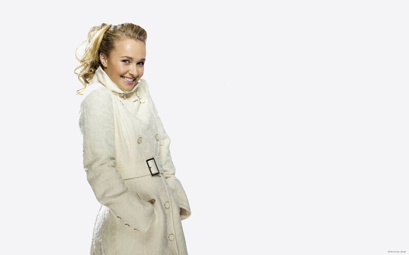 woman in white coat smiling