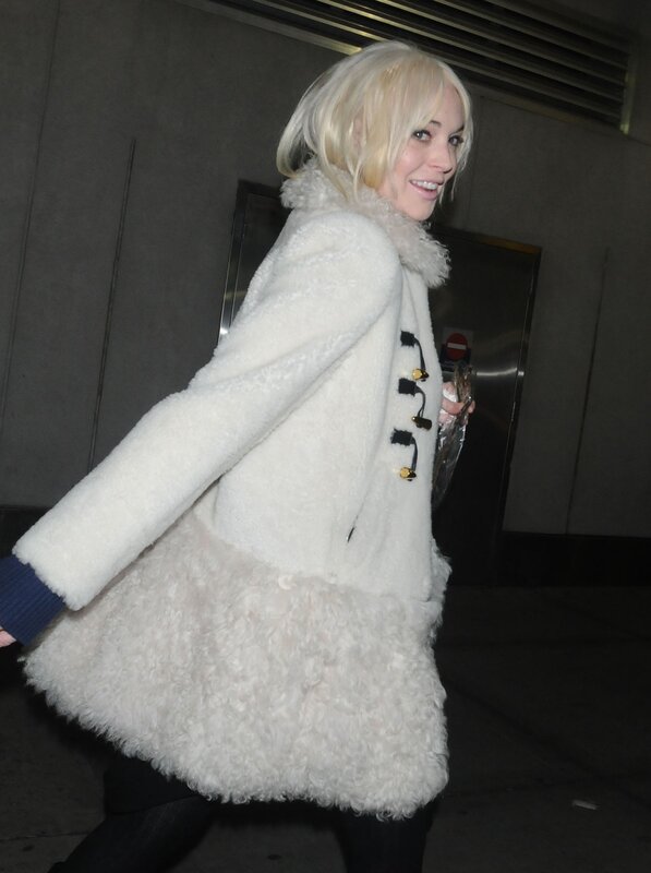 woman in white coat walking