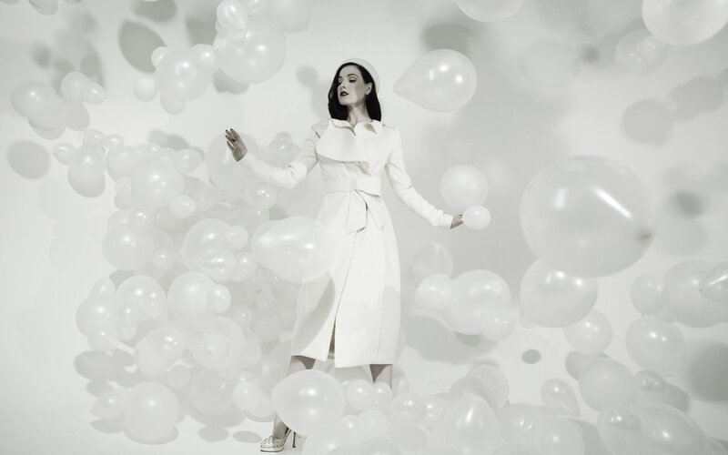 woman in white coat with balloons