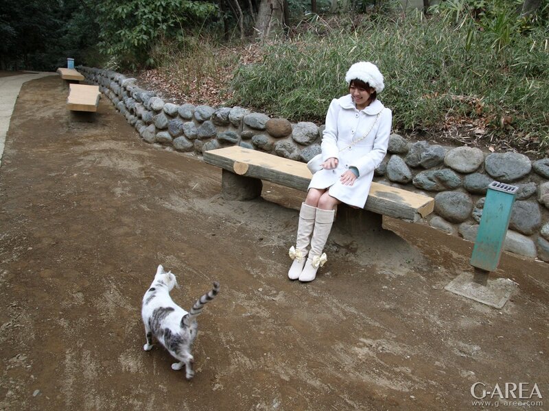 Woman in white coat with cat