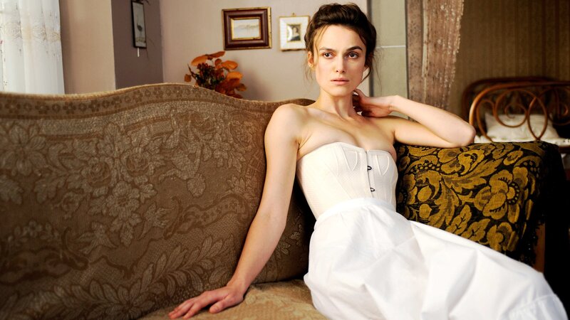woman in white corset on couch