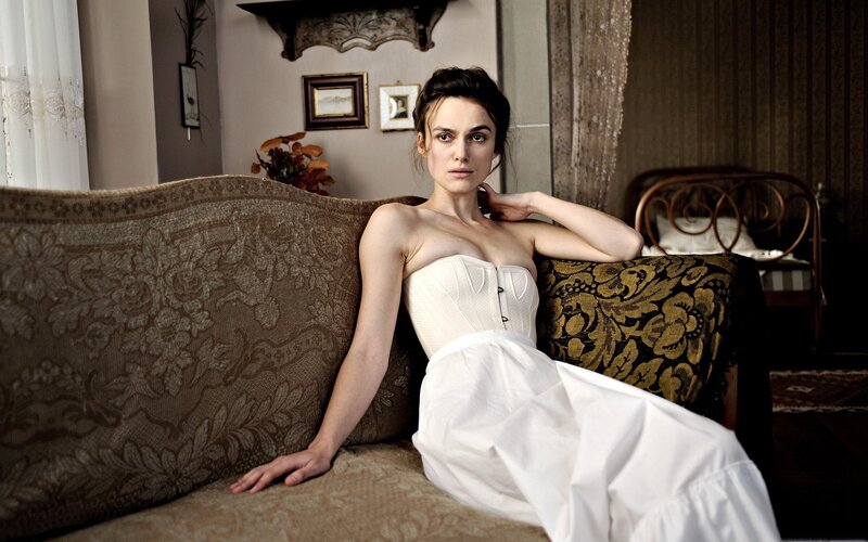 woman in white corset on couch