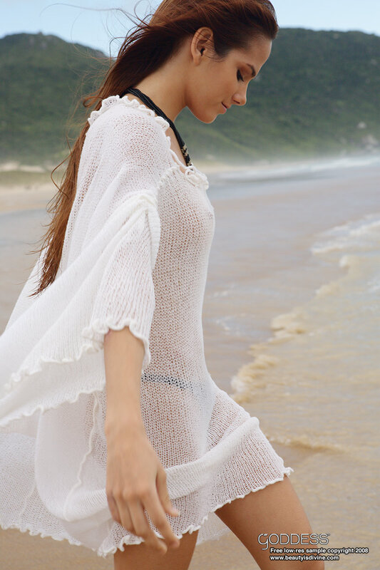 Woman in white cover-up on beach