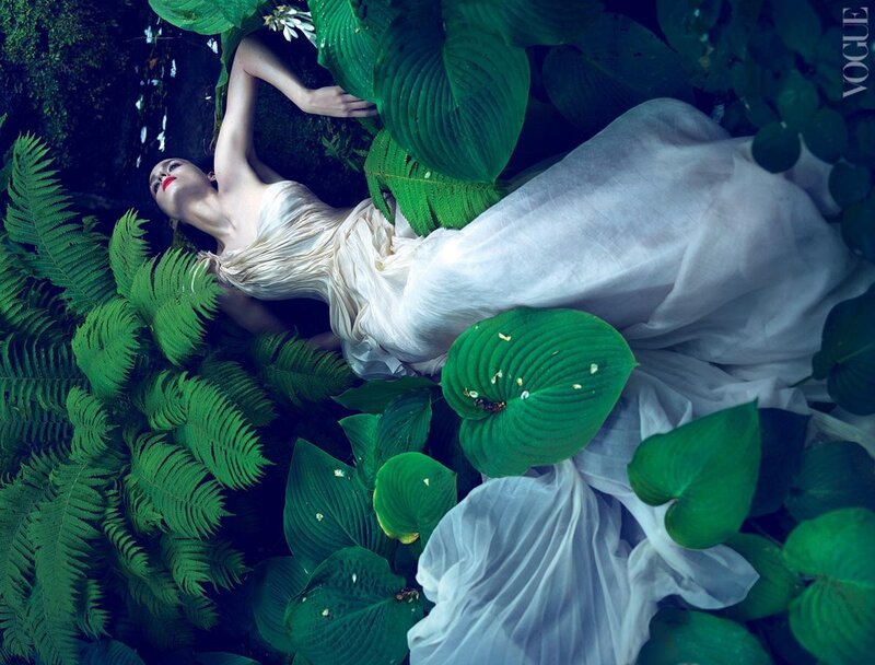 woman in white dress among green leaves