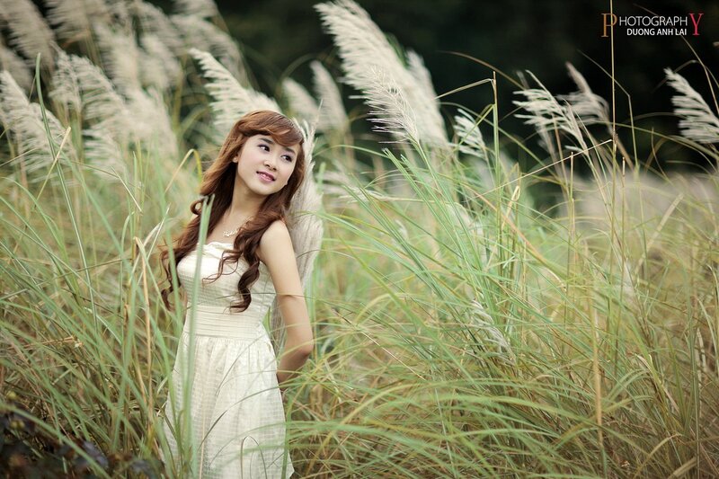 Woman in white dress among reeds