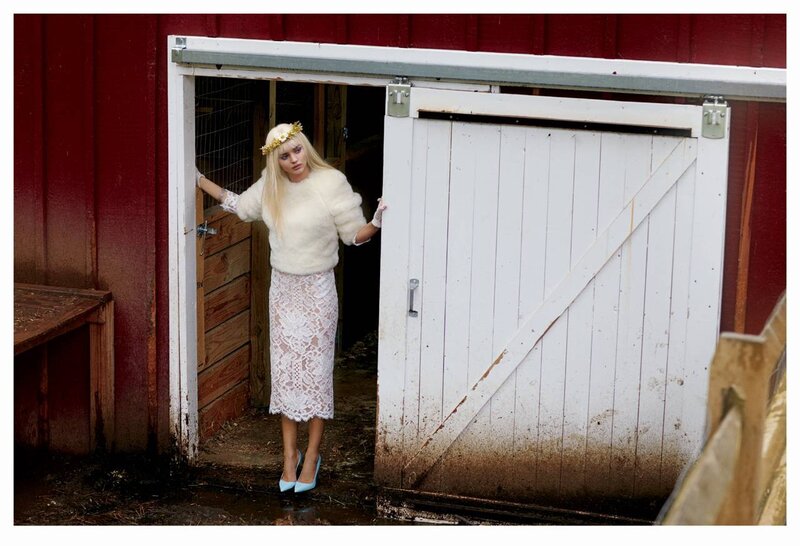 woman in white dress at barn door