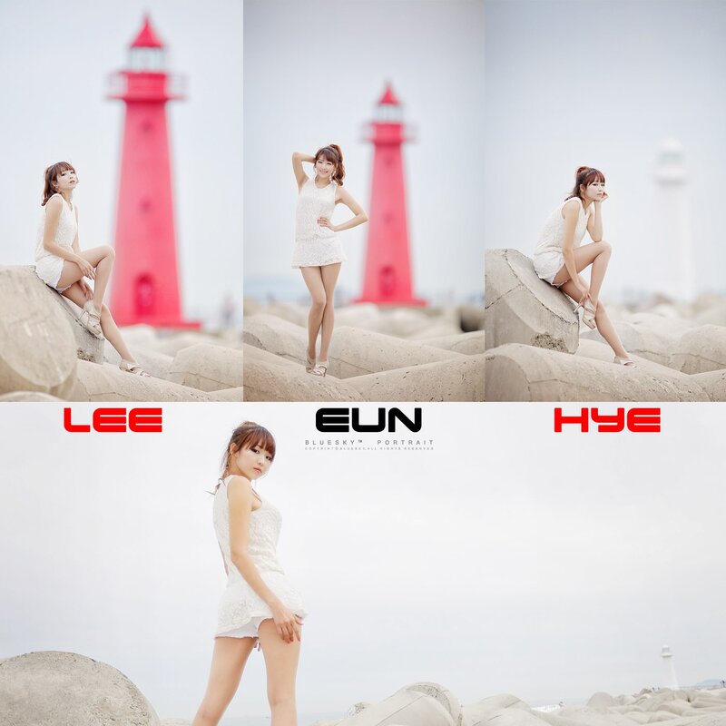 Woman in white dress at lighthouse