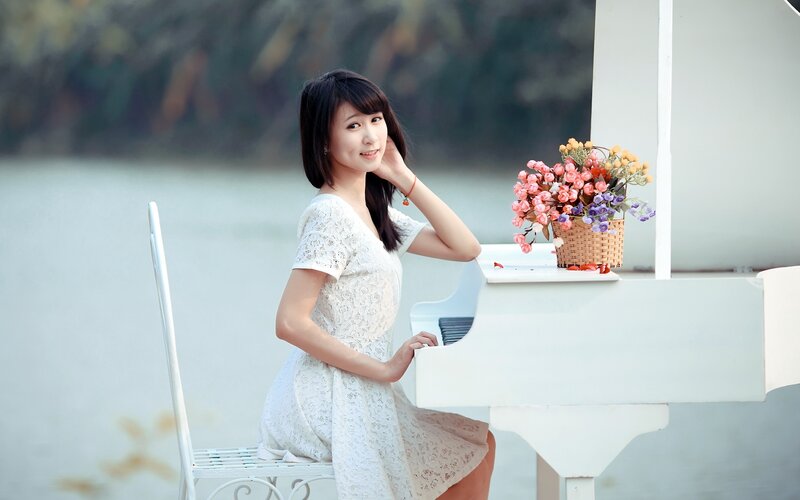 Woman in white dress at piano
