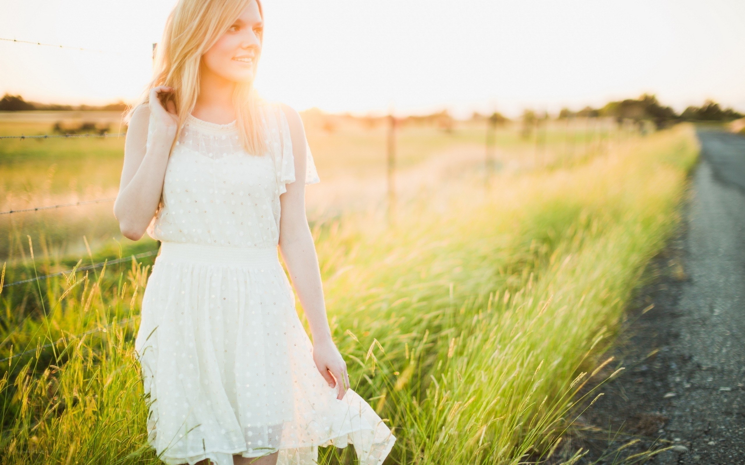 Woman in white dress at sunset