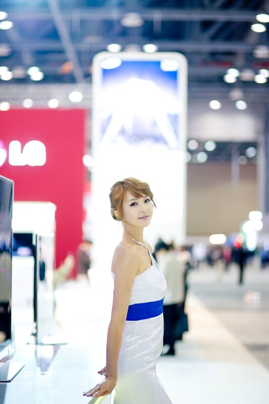 Woman in white dress at trade show