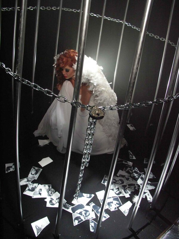 woman in white dress behind bars