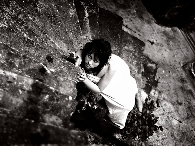 Woman in White Dress — Black, Dramatic, Photograph, Stone Wall
