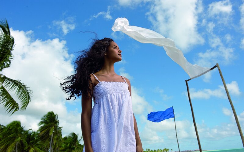 Woman in White Dress — Blue, Serene, Afternoon, Photograph, Palm Trees, Flags