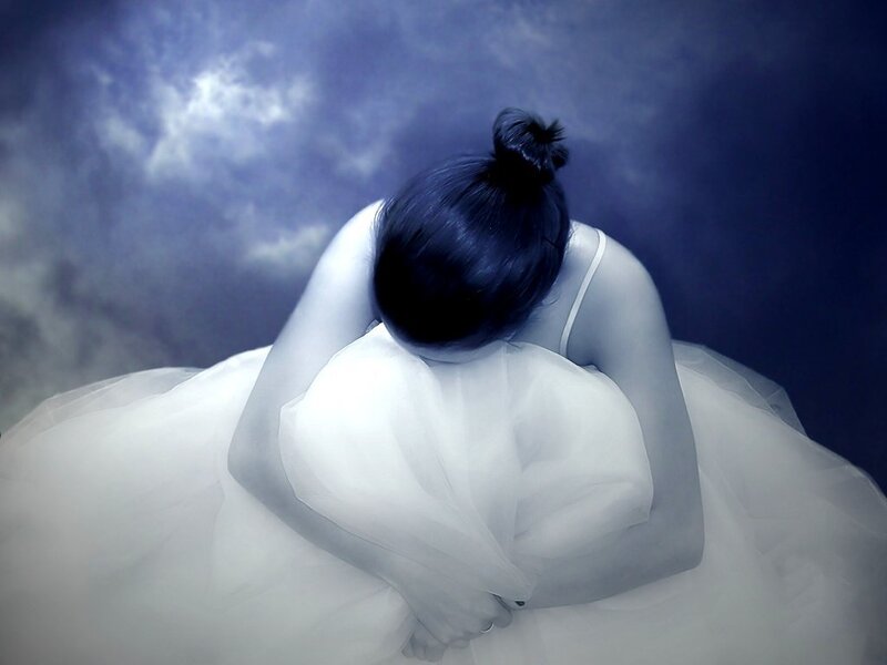 woman in white dress bowing