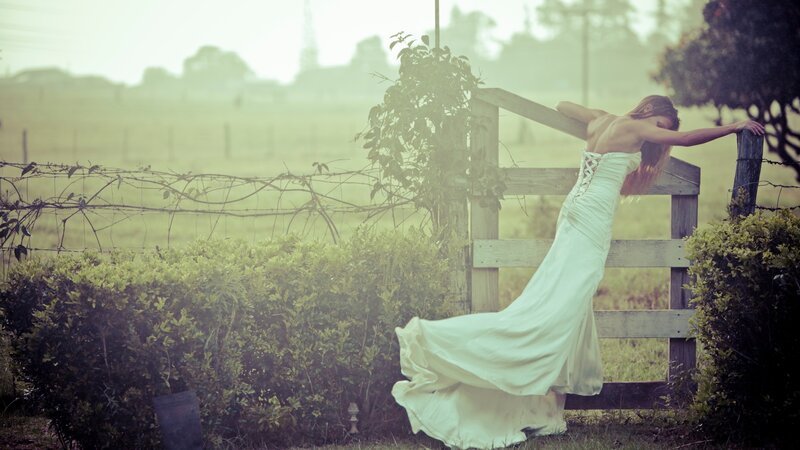 woman in white dress by fence