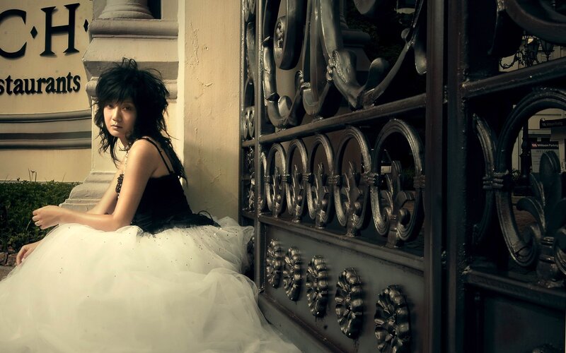 woman in white dress by gate