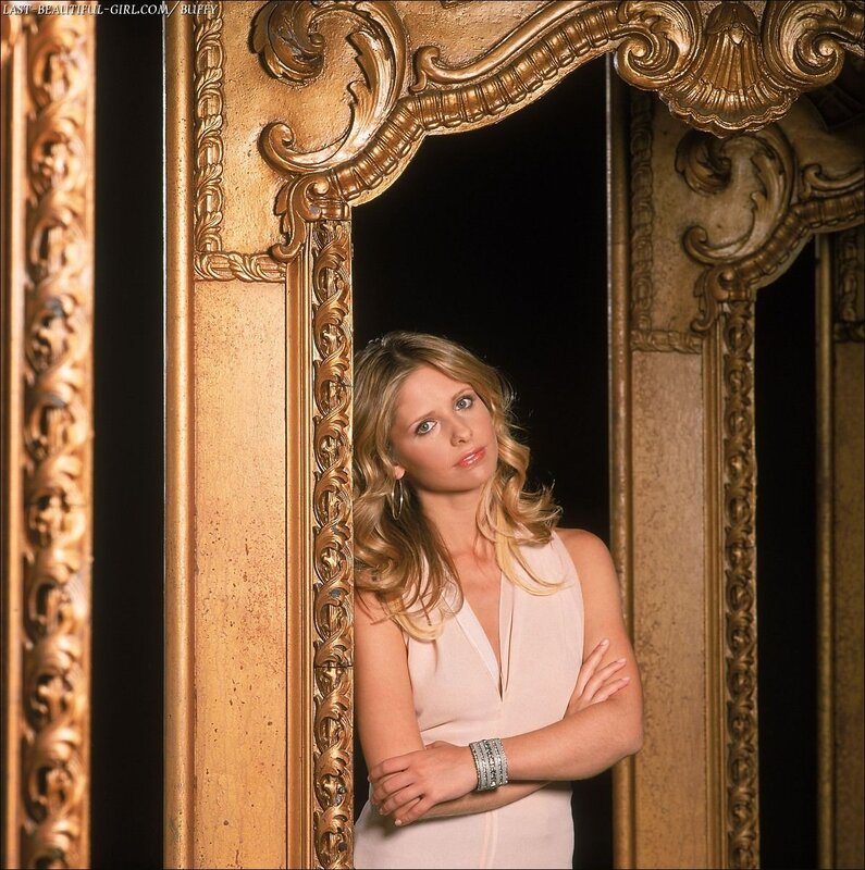 woman in white dress by ornate mirror