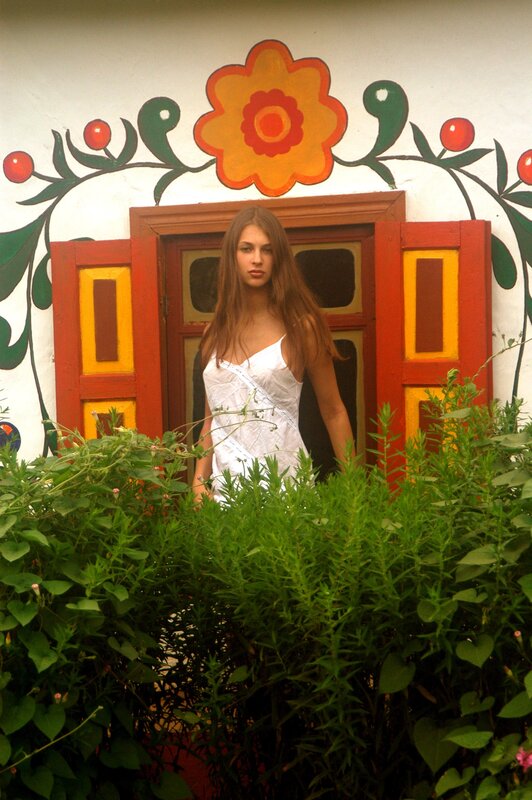 woman in white dress by painted door