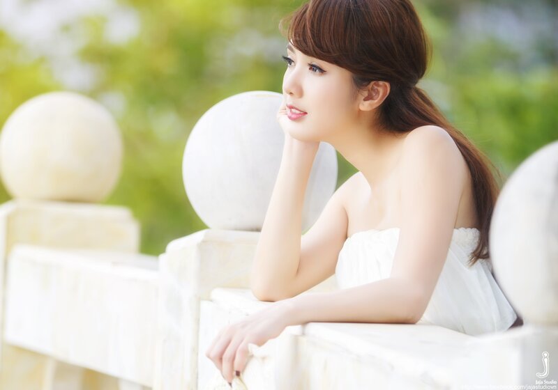 woman in white dress by railing