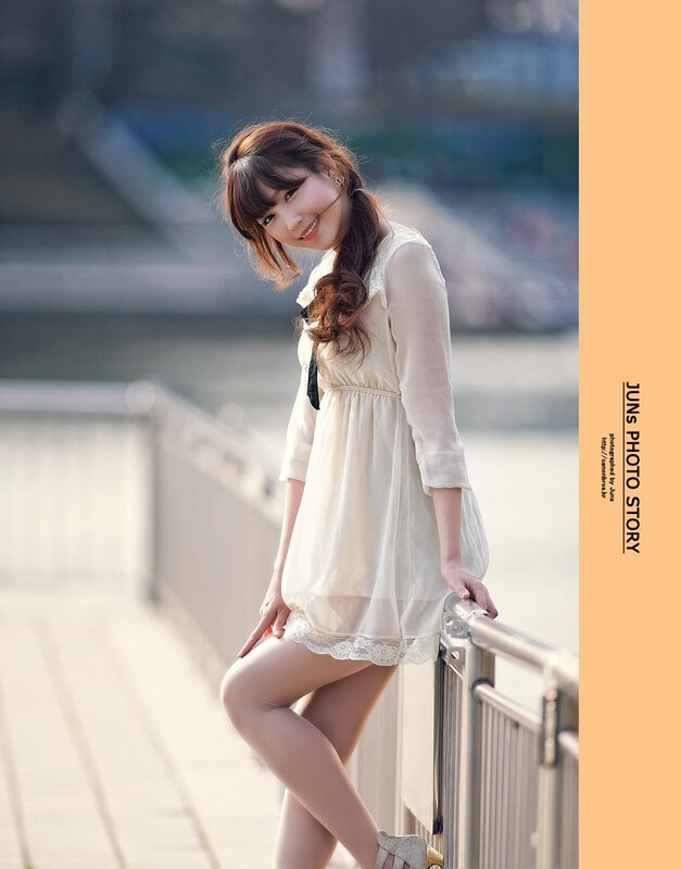 woman in white dress by railing