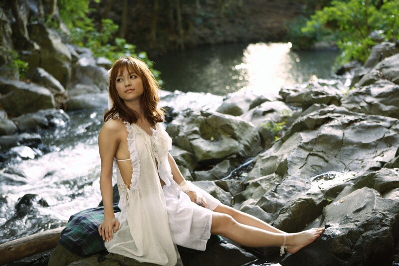Woman in white dress by stream