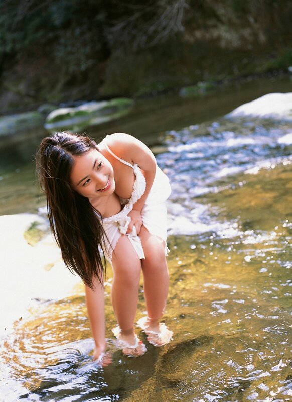 Woman in white dress by stream
