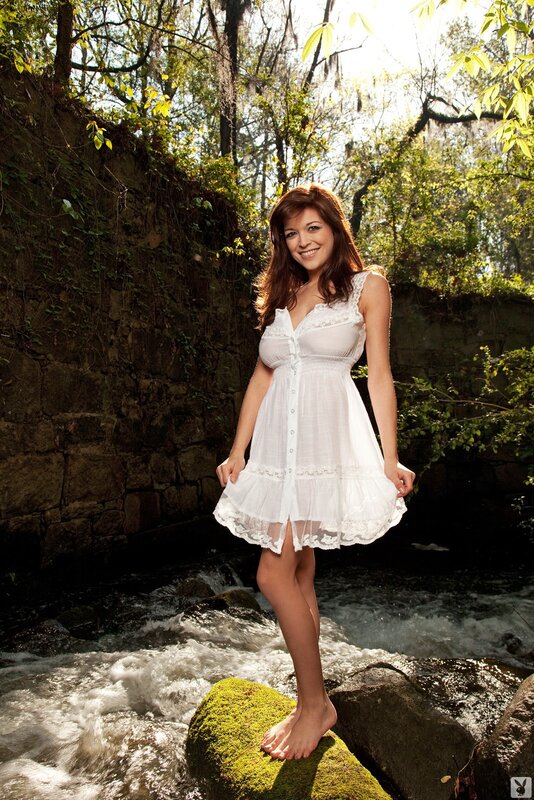 Woman in white dress by stream