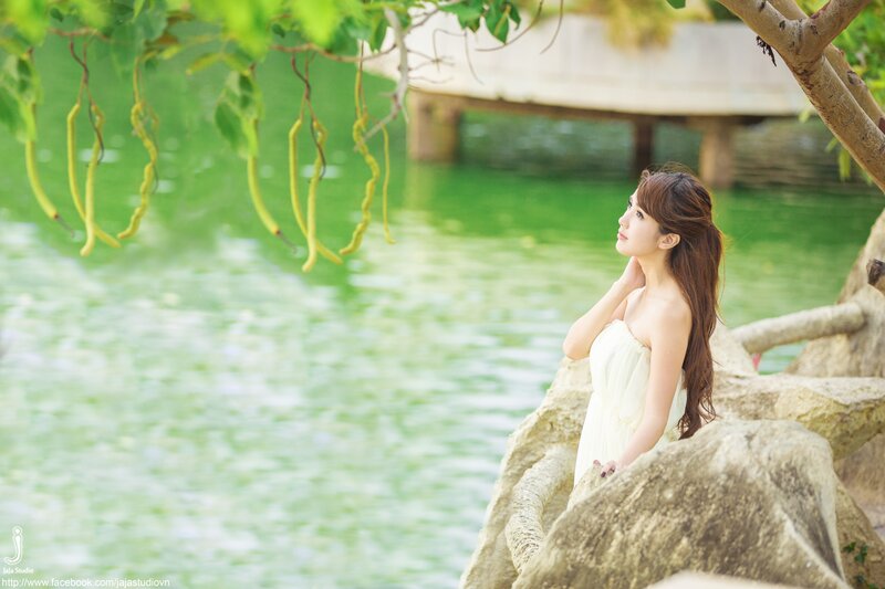 Woman in white dress by the lake
