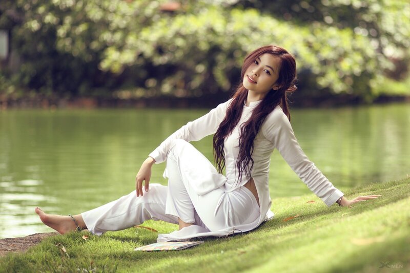 Woman in white dress by the lake