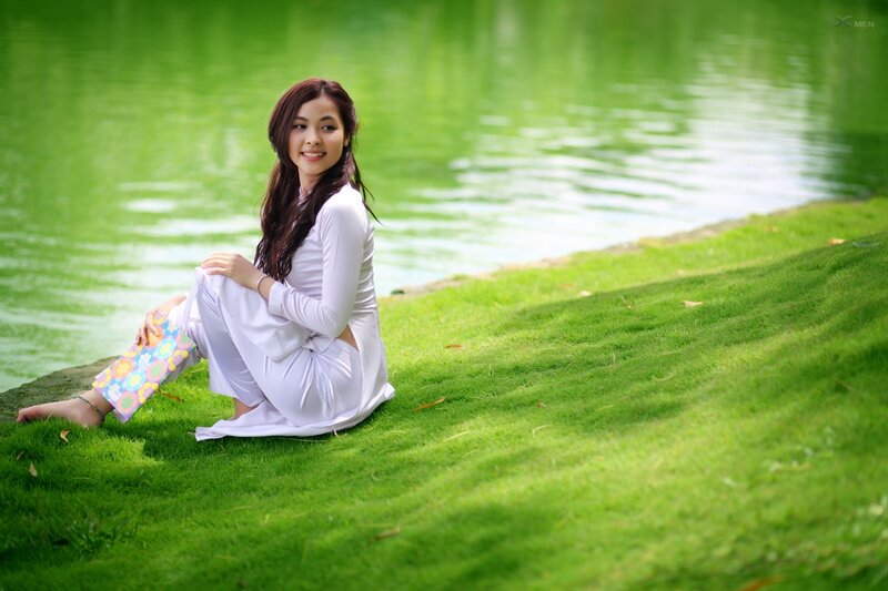 Woman in white dress by the lake