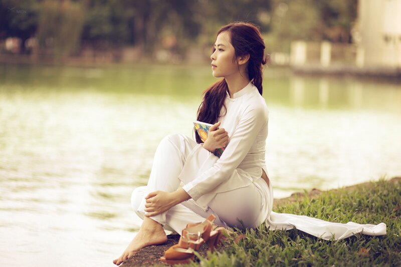 Woman in white dress by the lake