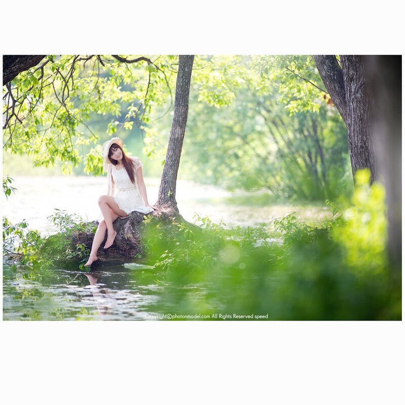 Woman in white dress by the lake