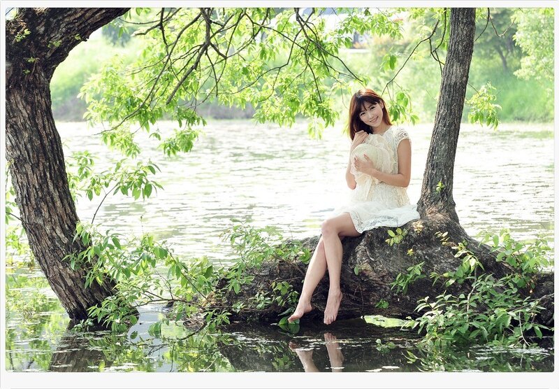 Woman in white dress by the lake