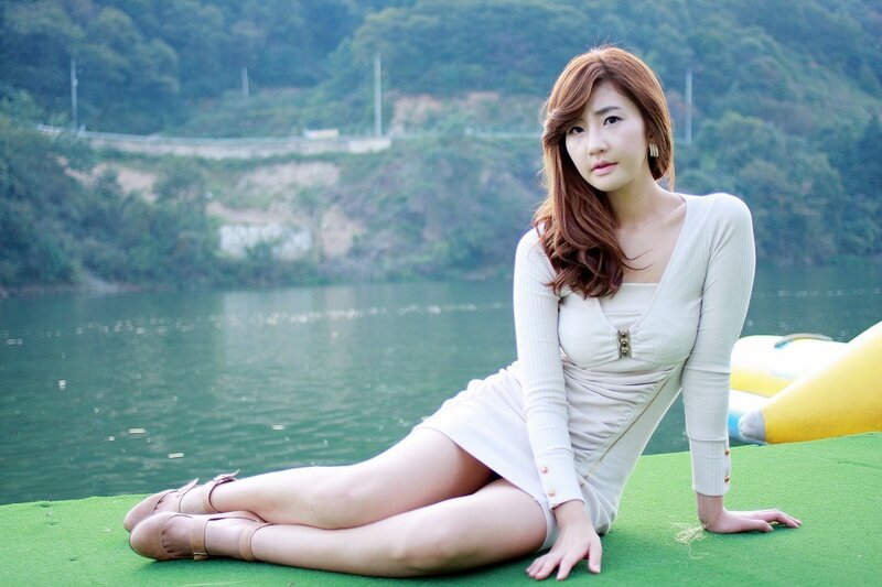 Woman in white dress by the lake