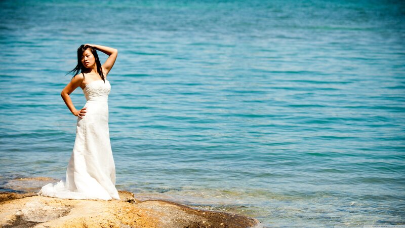 woman in white dress by the sea