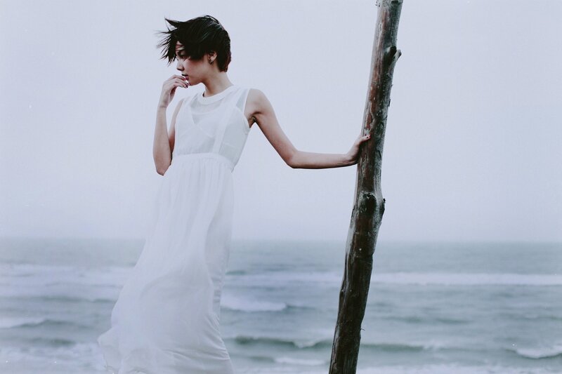 woman in white dress by the sea