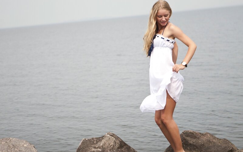 woman in white dress by the sea
