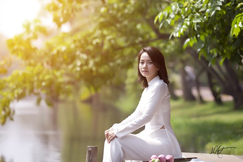 Woman in white dress by the water
