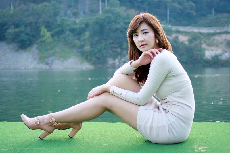 Woman in white dress by the water