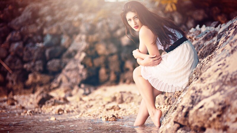 woman in white dress by the water