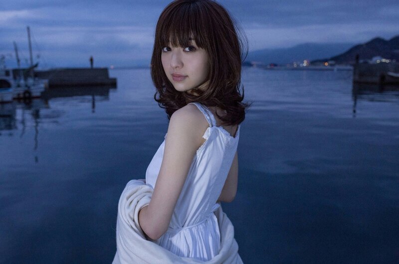 woman in white dress by the water