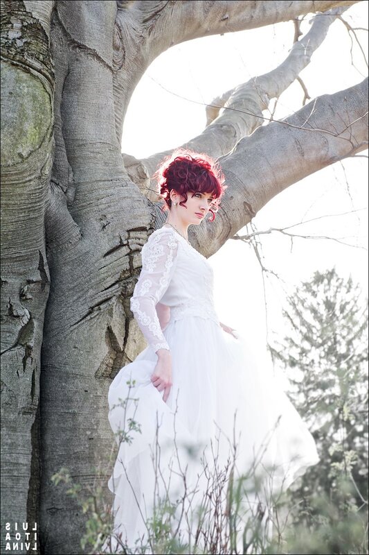 Woman in white dress by tree