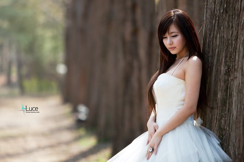 woman in white dress by tree