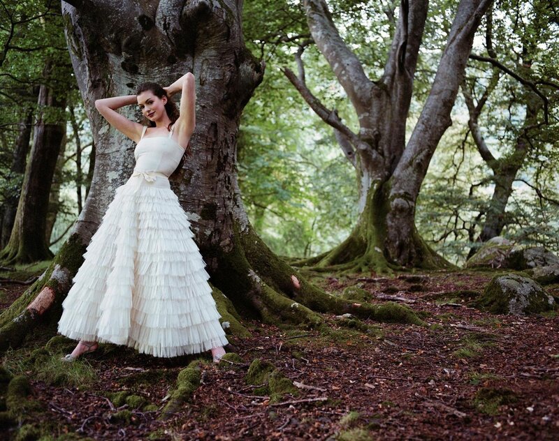 Woman in white dress by tree