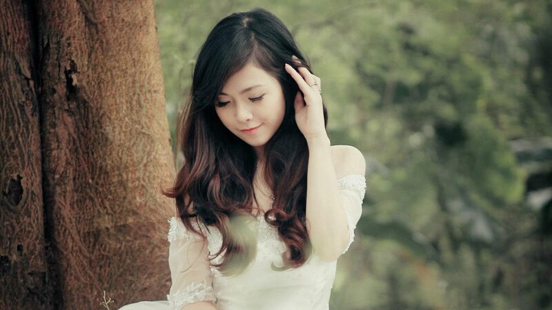 woman in white dress by tree
