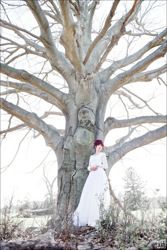 Woman in white dress by tree
