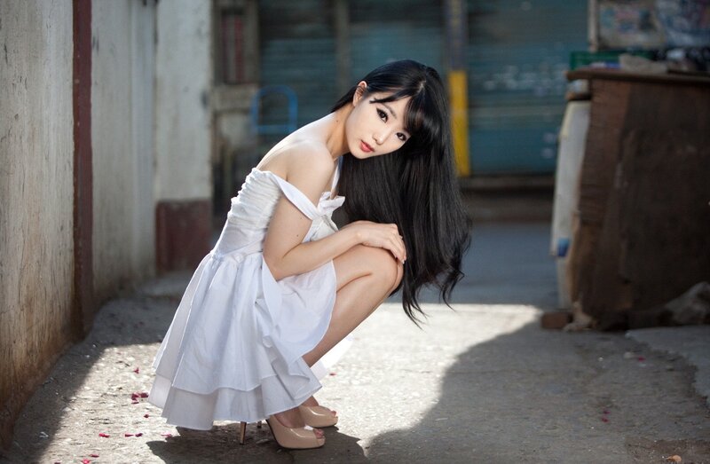 woman in white dress crouching