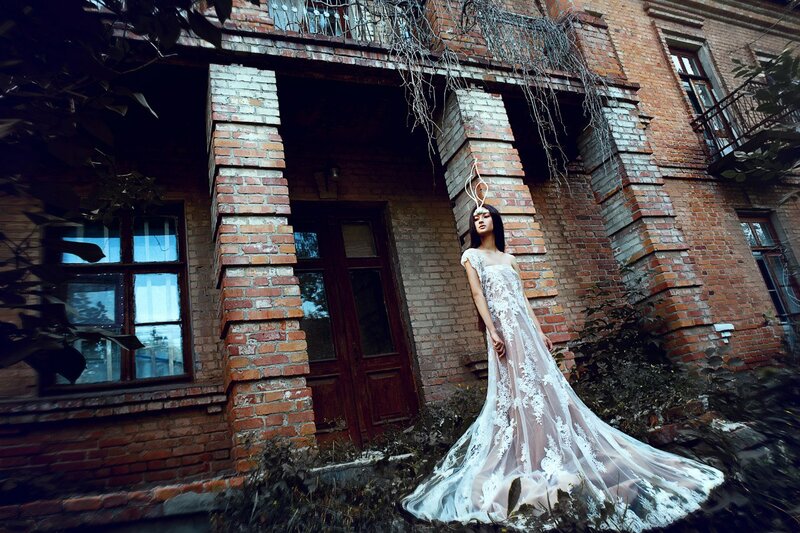 Woman in White Dress — Dramatic, Photograph, Brick Building