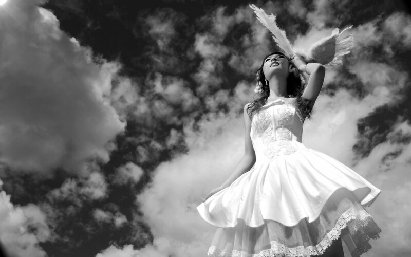Woman in White Dress — Dramatic, Photograph, Feather, Clouds
